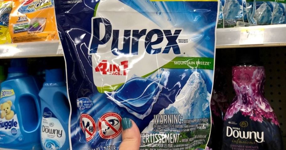 Hand holding up a bag of Purex Laundry Detergent Packs