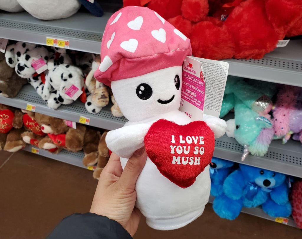 a womans hand displaying a white mushroom plush dool