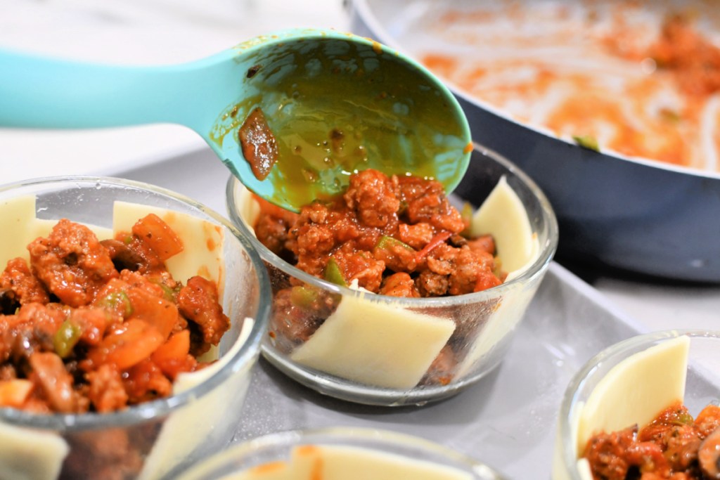 adding sausage filling to pizza pot pies