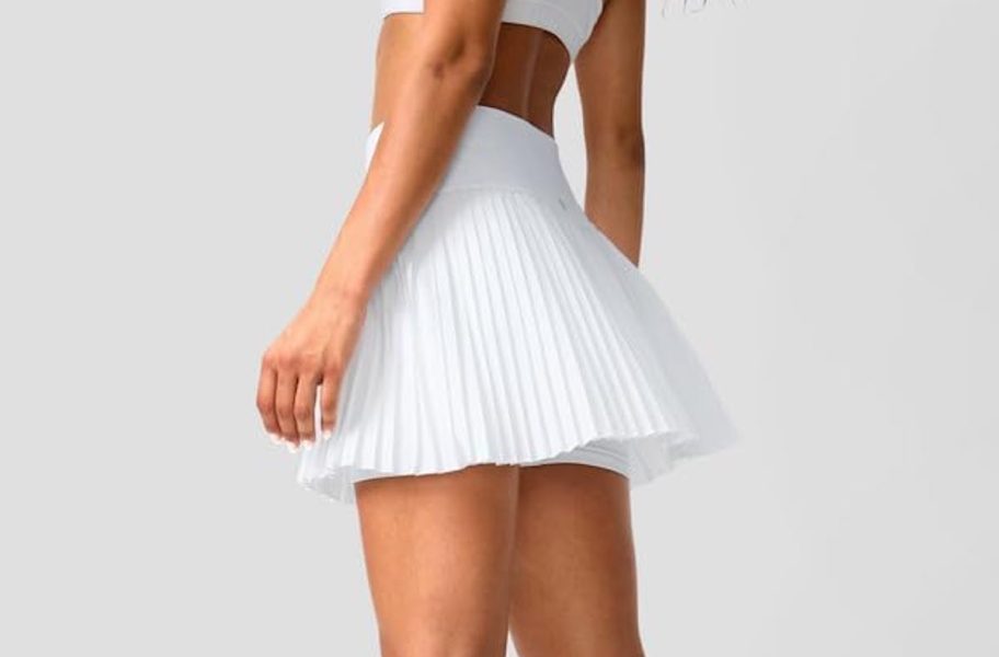 stock photo of woman wearing white pleated tennis skirt