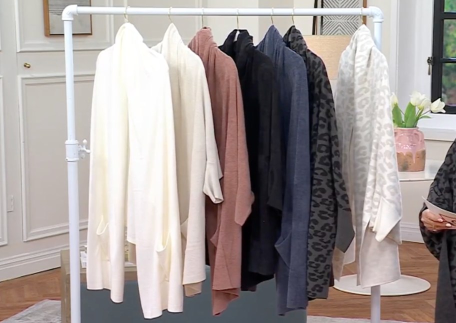 many cardigans on hanging rack