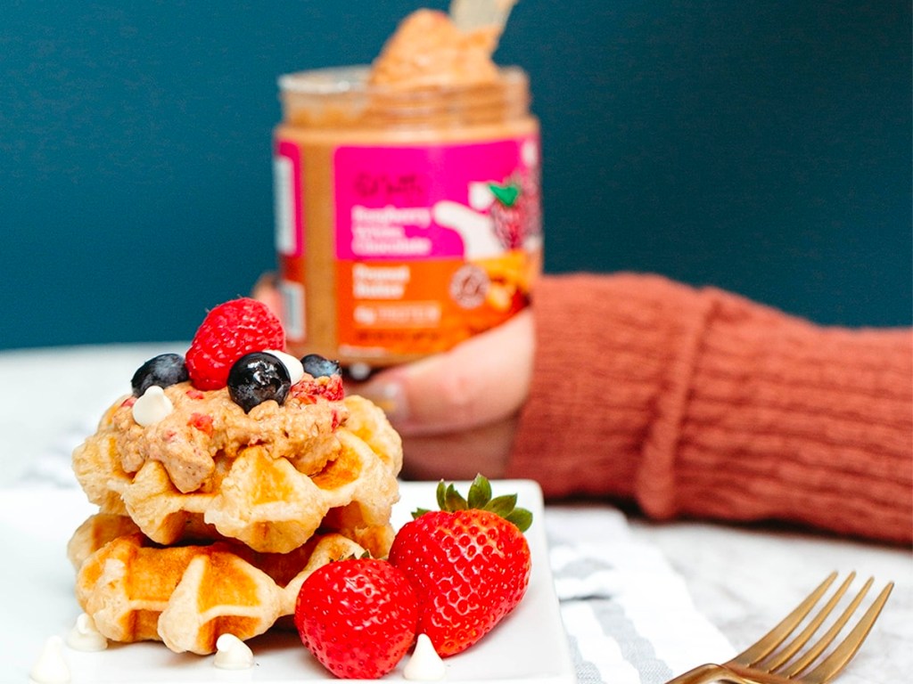 waffles and strawberries with peanut butter on top