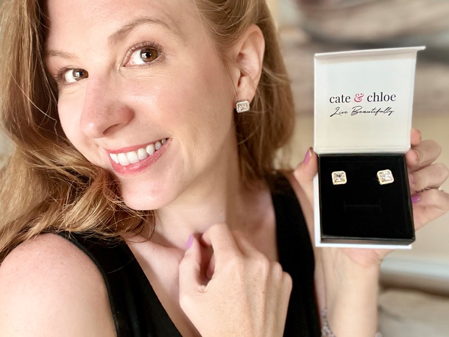 woman holding cate and chloe earrings box