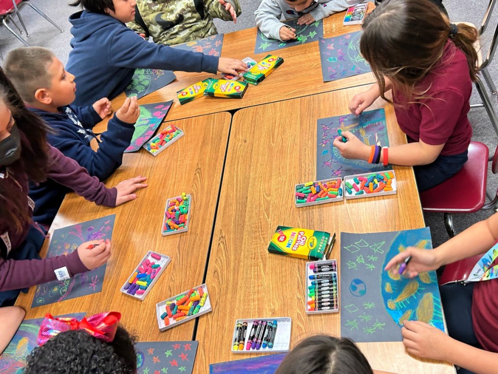 kids making art around a classroom table