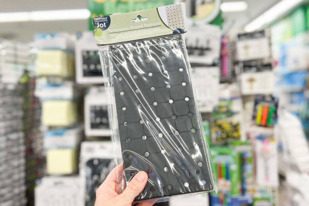 hand holding black peg board in store at dollar tree