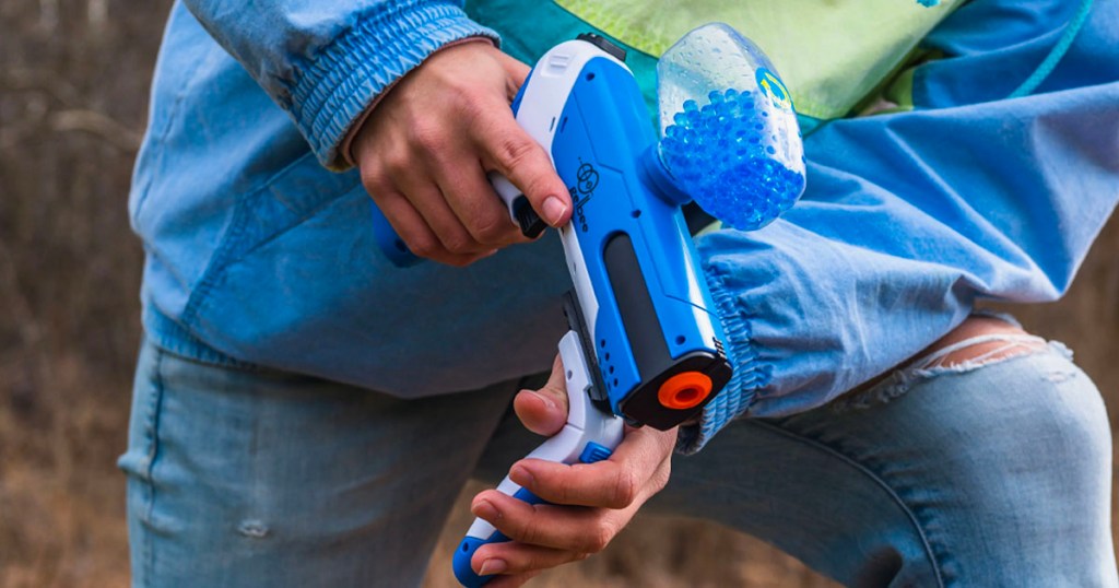 hands holding blue water gel blaster