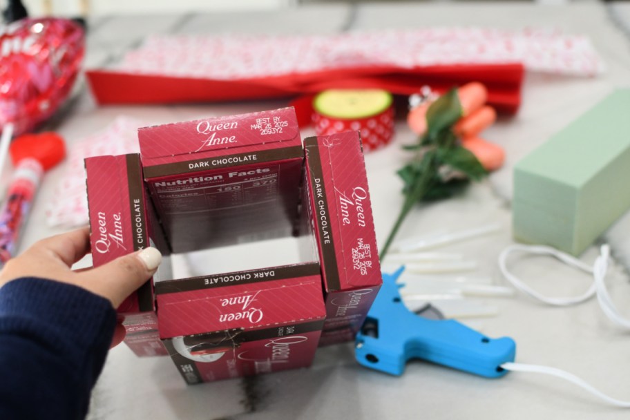 gluing four boxes of candy together as a base for bouquet