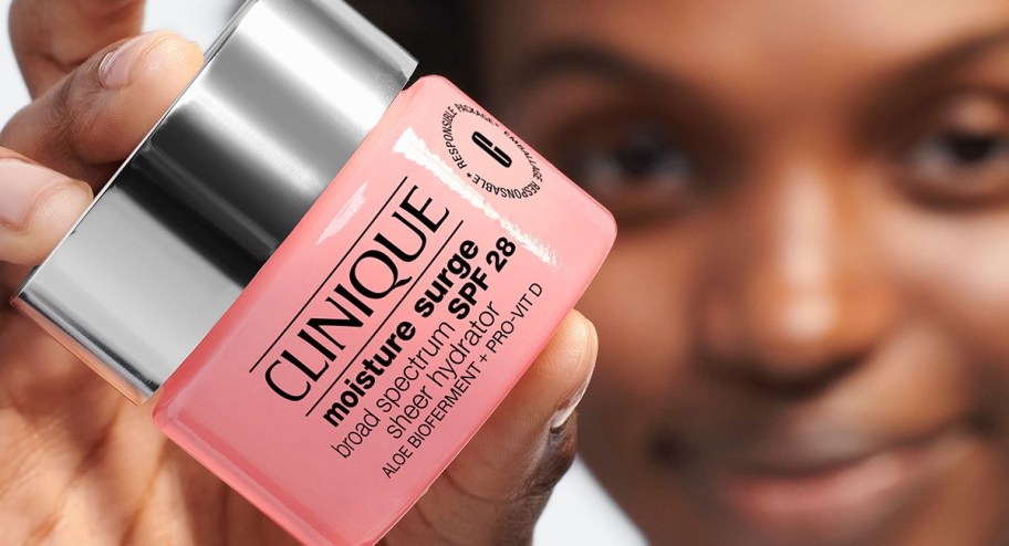 hand holding Clinique moisture surge cream