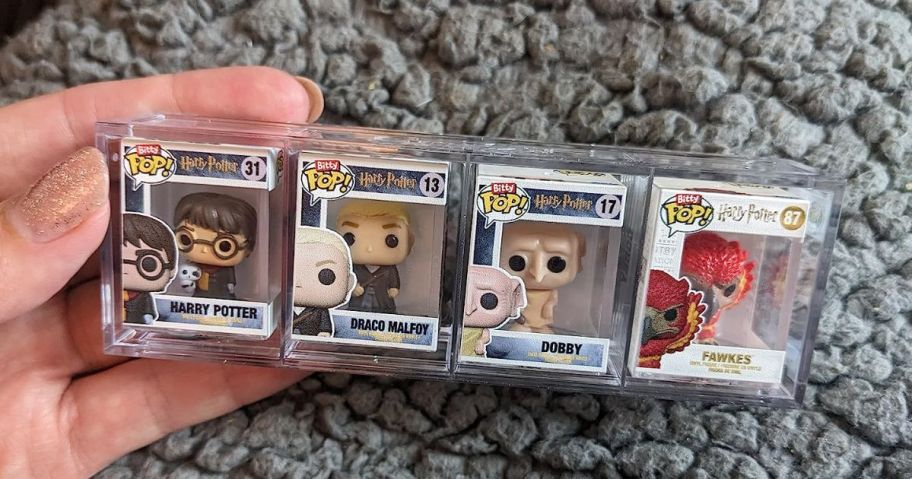 Funko Bitty Pop! Harry Potter Mini Collectible Toys 4-Pack being held by hand on blanket