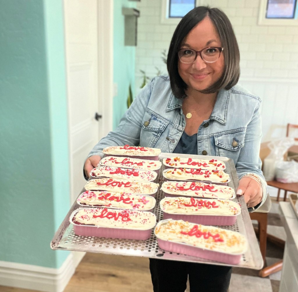 holding a tray with mini loaf cakes