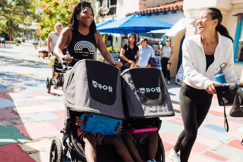 women running race with jogging stroller