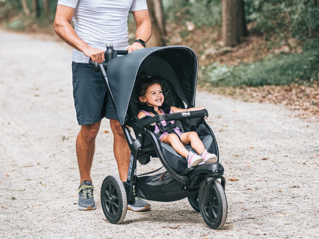 man pushing jogging stroller