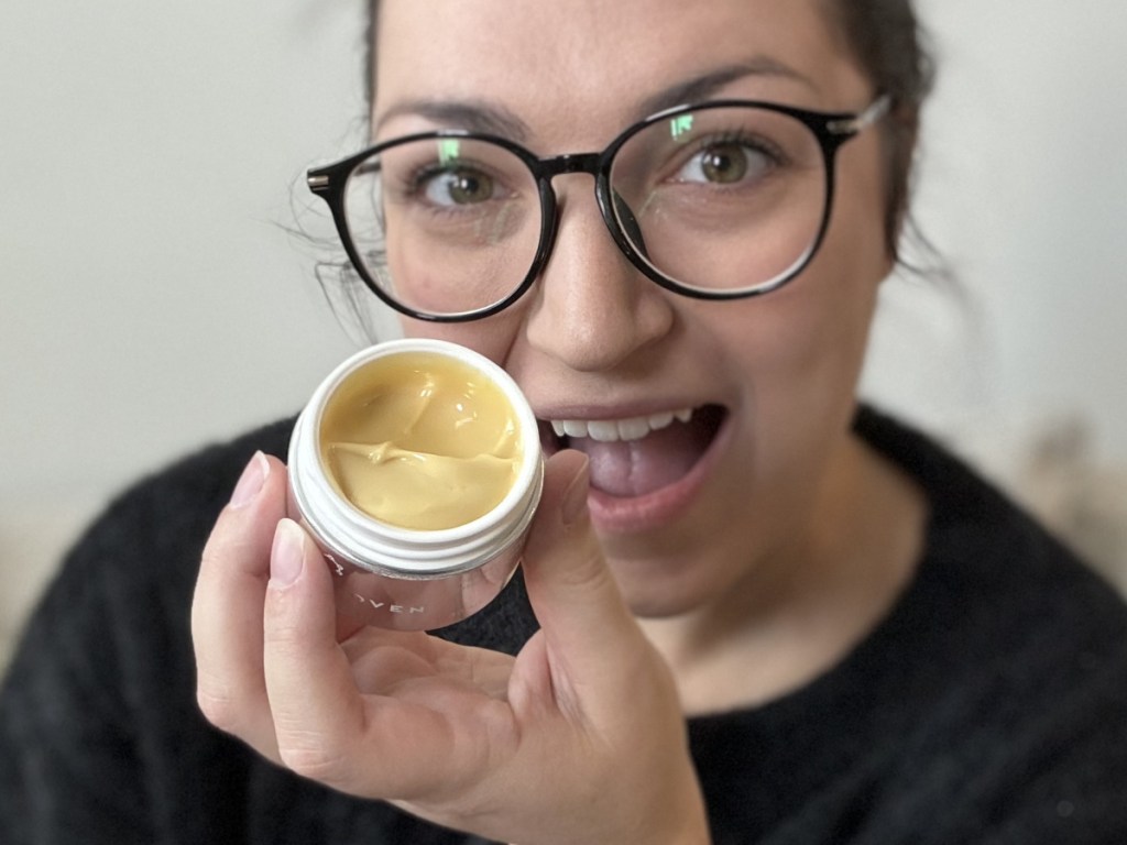 woman holding night cream with lid off