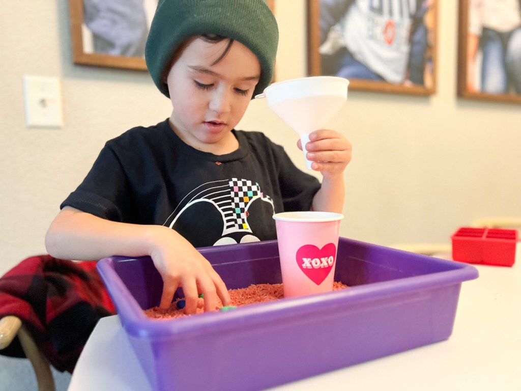 kid playing with sensory bin