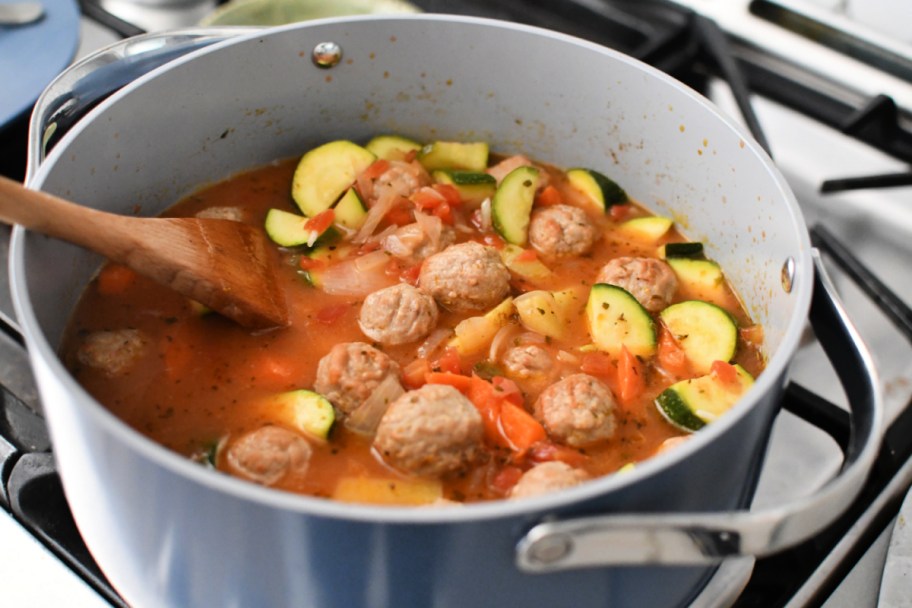 stirring albondigas soup