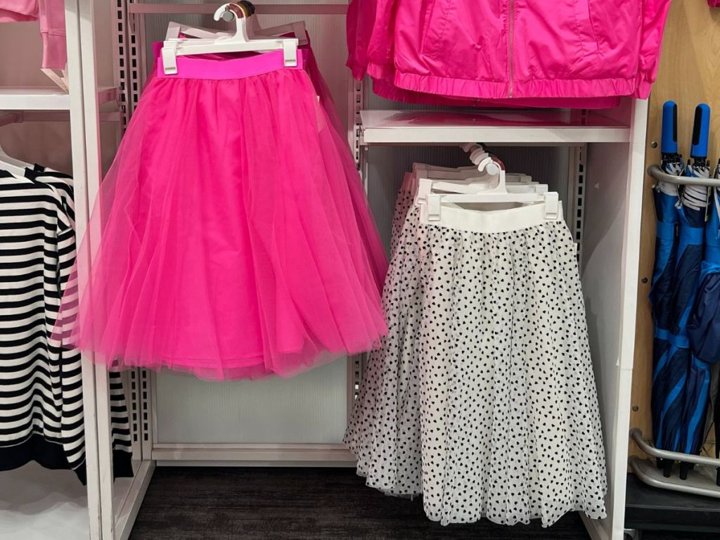 women's pink and black and white tulle skirts hanging on display