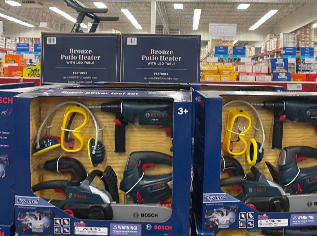 toy power tool sets stacked on a shelf in a store