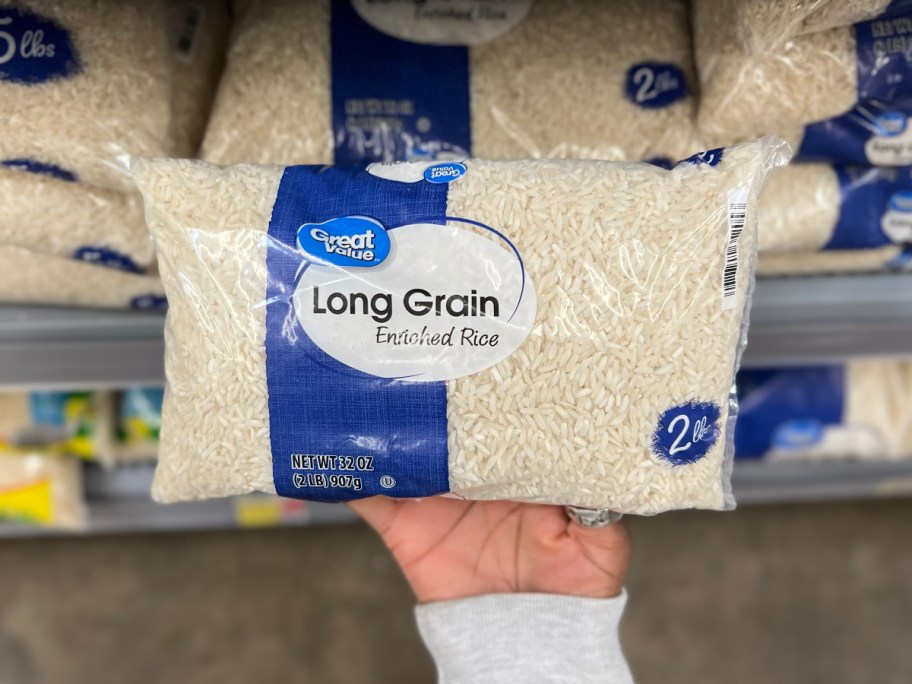 holding a bag of white rice