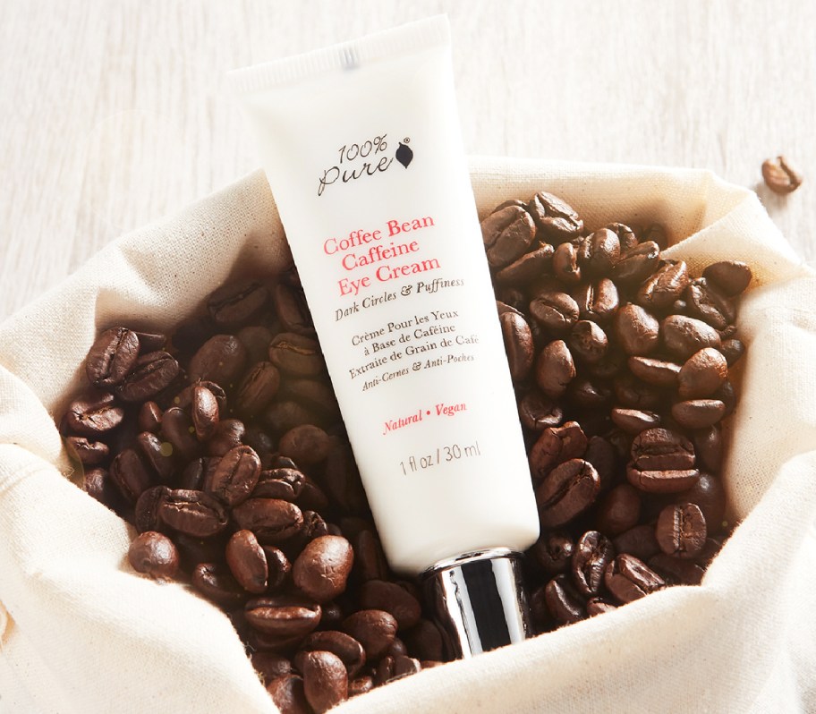 eye cream in bowl of coffee beans