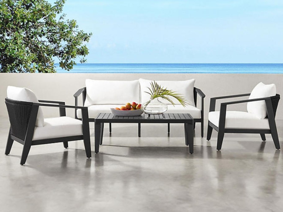 black outdoor patio furniture set with cream cushions 