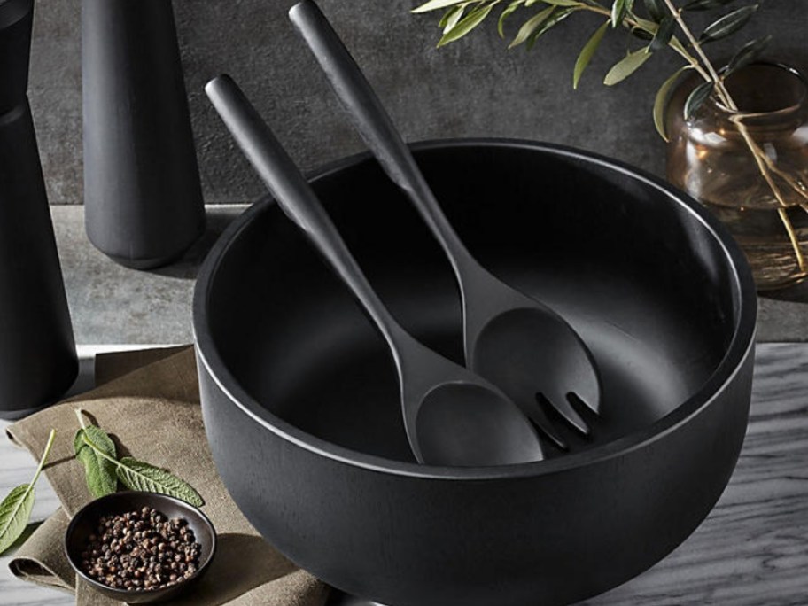 black wood salad bowl and serving spoons on a table