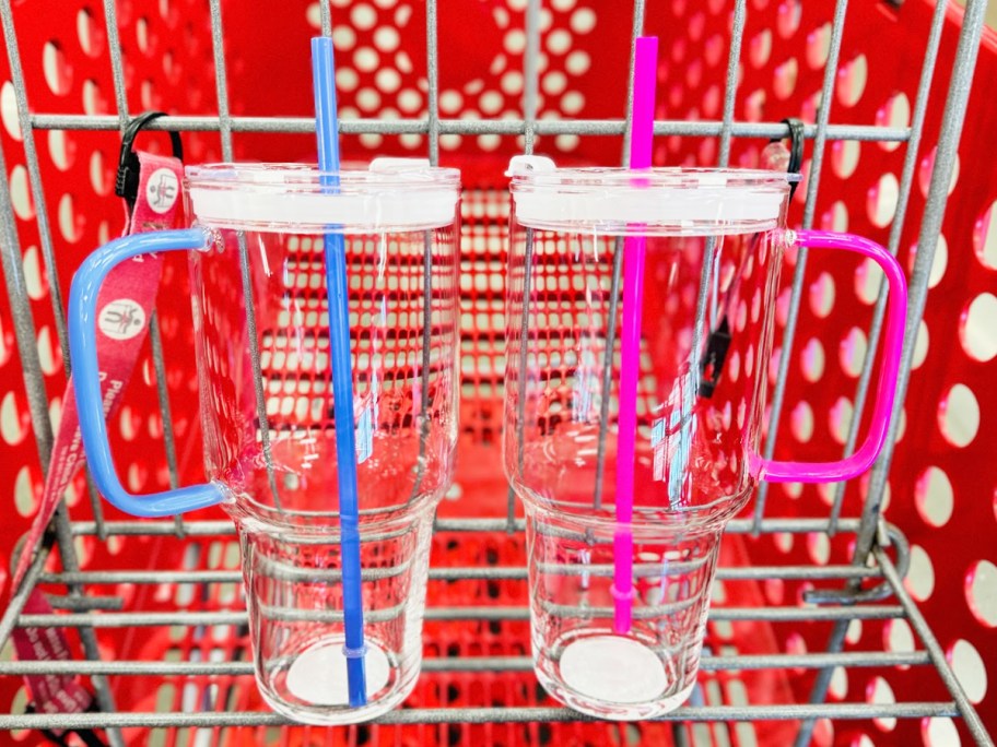 glass tumblers with blue and pink straws and handles in red shopping cart