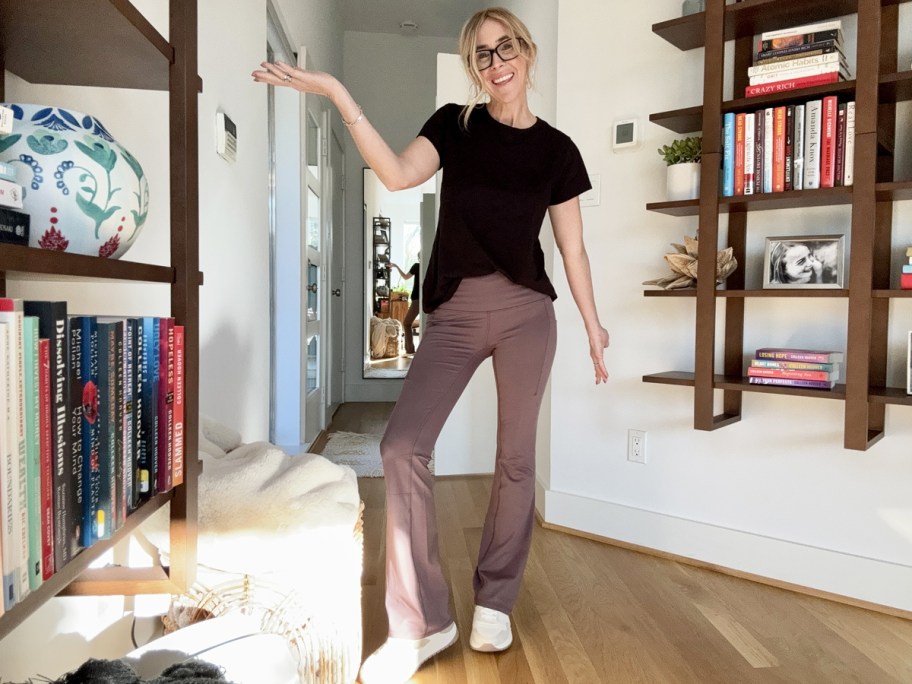 woman in black tee with mauve yoga pants