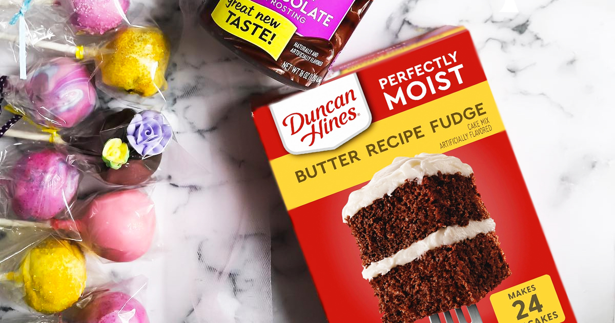 box of Duncan Hines Perfectly Moist Butter Recipe Fudge Cake Mix near cake pops and can of frosting