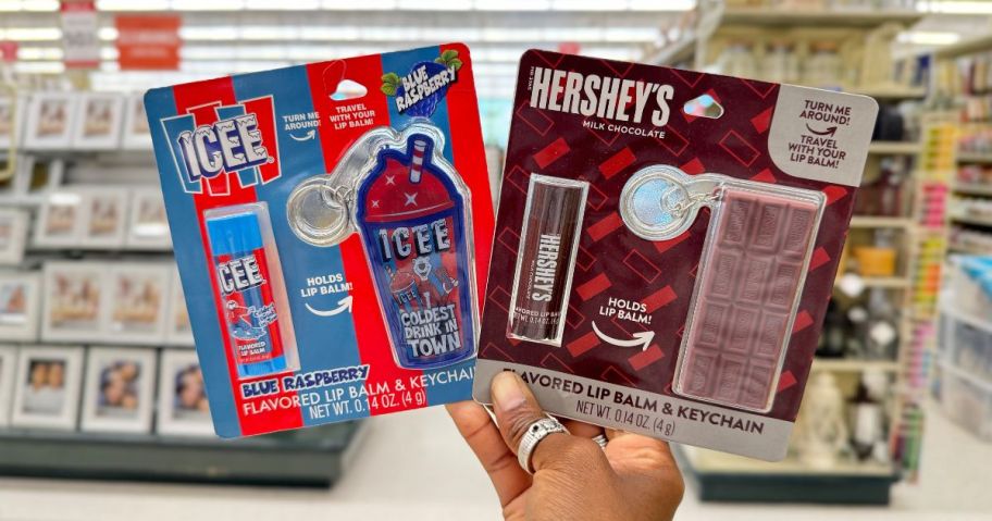 A hand holding Flavored Balm & Keychain Gift Sets in Hobby Lobby