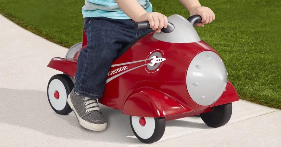 little boy riding on a Radio Flyer Rocket toy outside