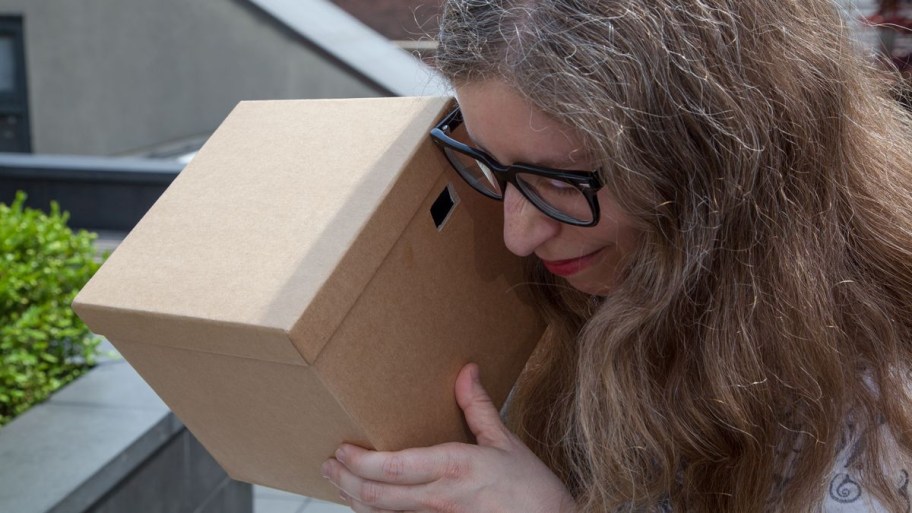 Woman looking through a DIY Solar Viewer she created thanks to Live Science