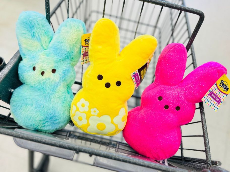 A Walgreens shopping cart with 3 Peeps Plush Bunnies in the front basket