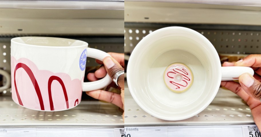 hand holding up a mug with a tiny donut at the bottom