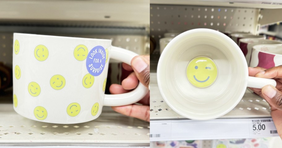 hand holding an smiley print mug with a smiley face inside at the bottom