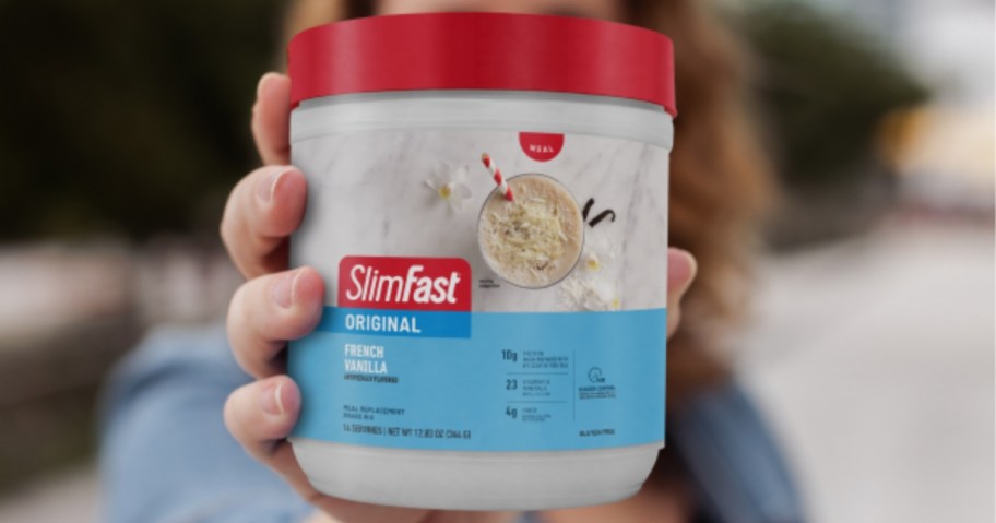woman holding SlimFast Meal Replacement Shake Powder 12.83oz canister