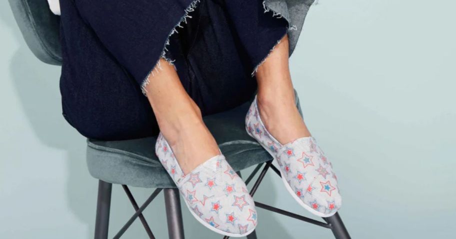 woman on a stool wearing TOMS Alpargata Cloudbound Women's Shoes in Glow in the Dark Stars