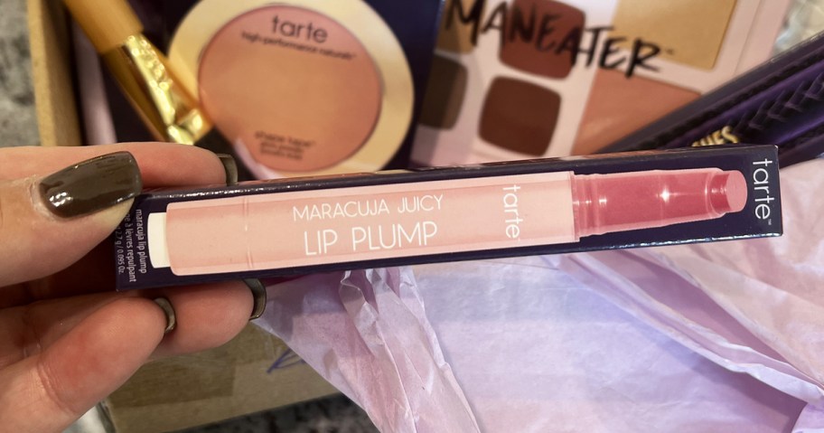 hand holding Tarte Maracuja Juicy Lip Plump