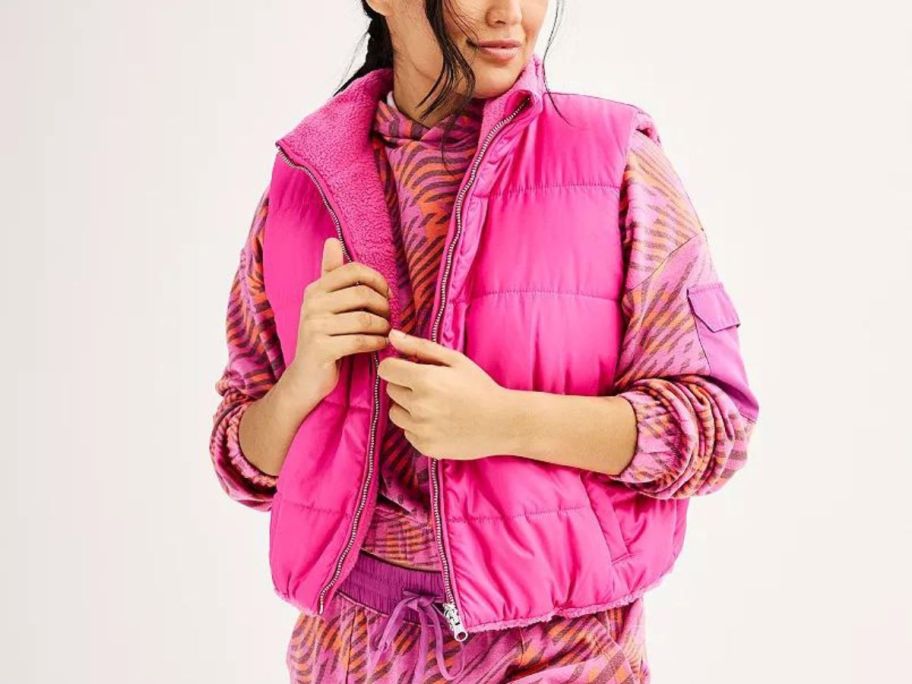 A woman wearing a pink Tek Gear Cropped Reversible Vest