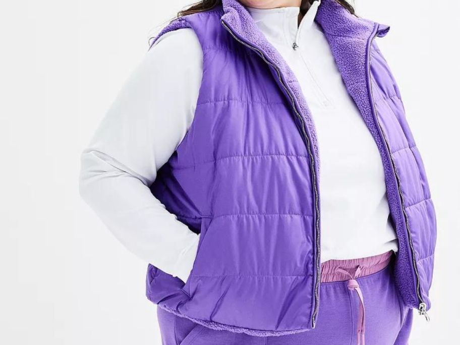 A woman wearing a purple Tek Gear Plus Sized Cropped Reversible Vest