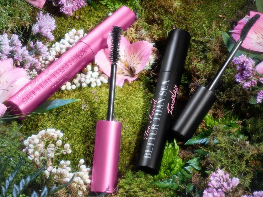 pink and black tubes of Too Faced Naturally Better Than Sex Mascara and Primer in flowers