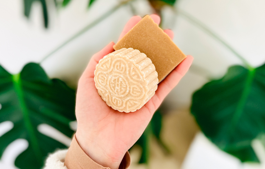 hand holding shampoo and conditioner bar