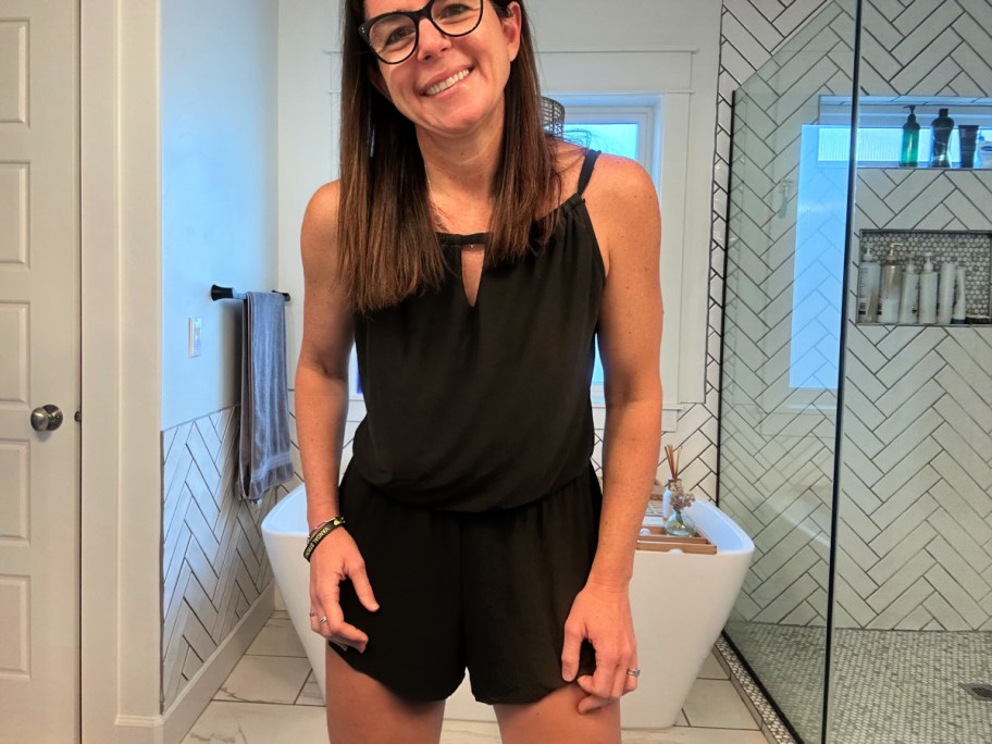 lady wearing black swim romper in bathroom