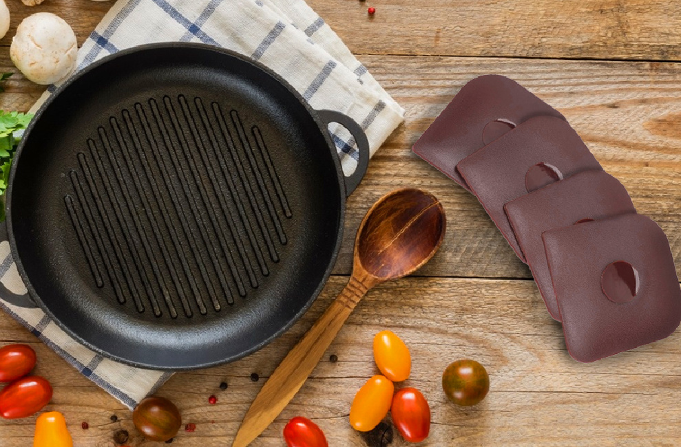 cast iron pan displayed with 4 pan scrapers on the side