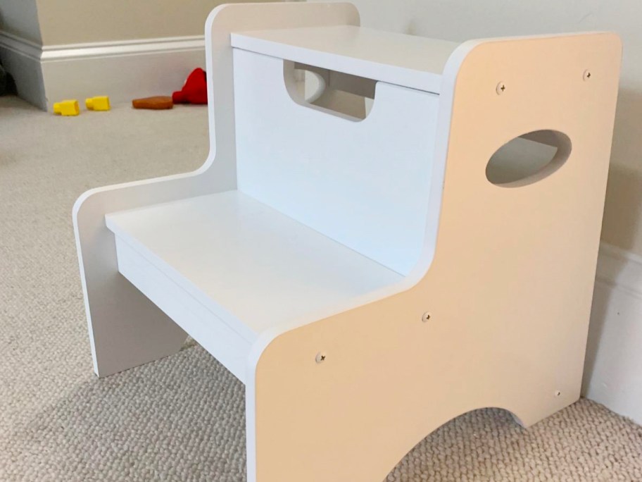 white wooden step stool in bedroom