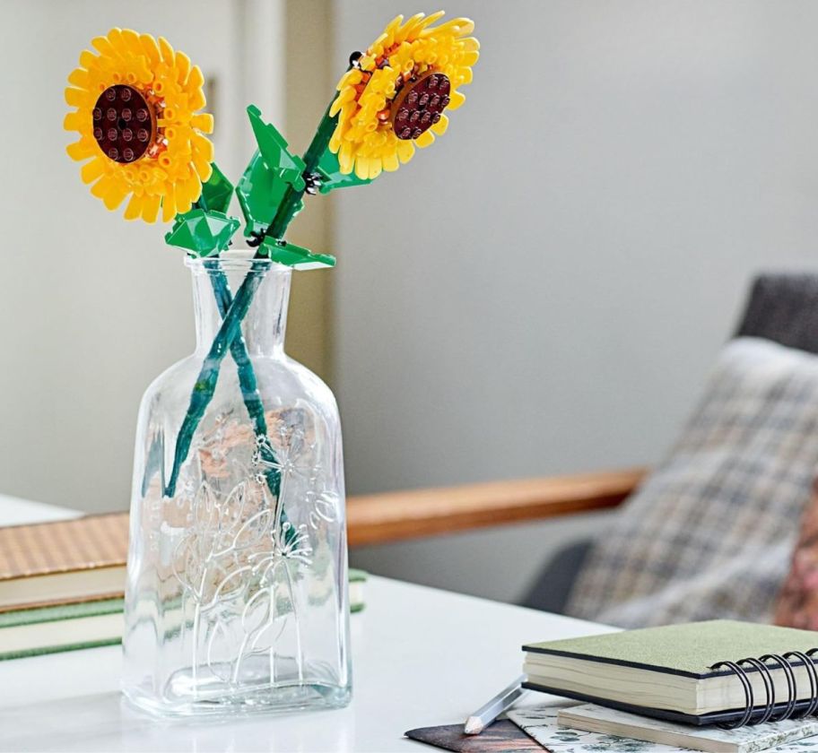 2 lego sunflowers in an old glass jug