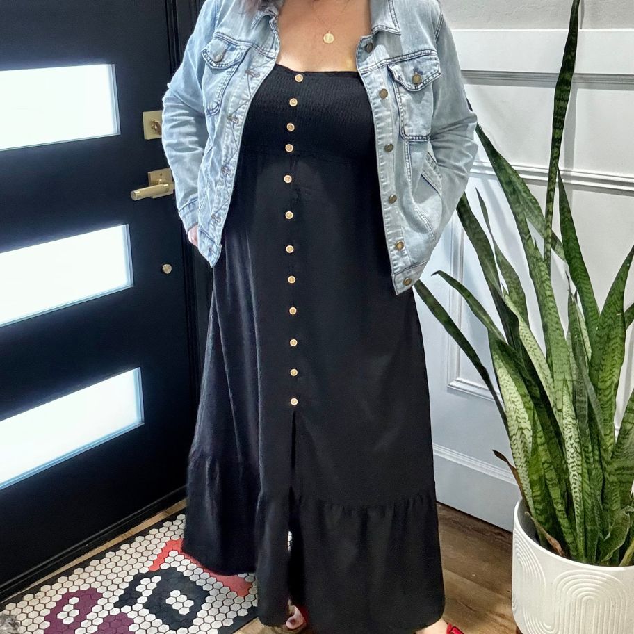 woman waring a black sundress with a jean jacket