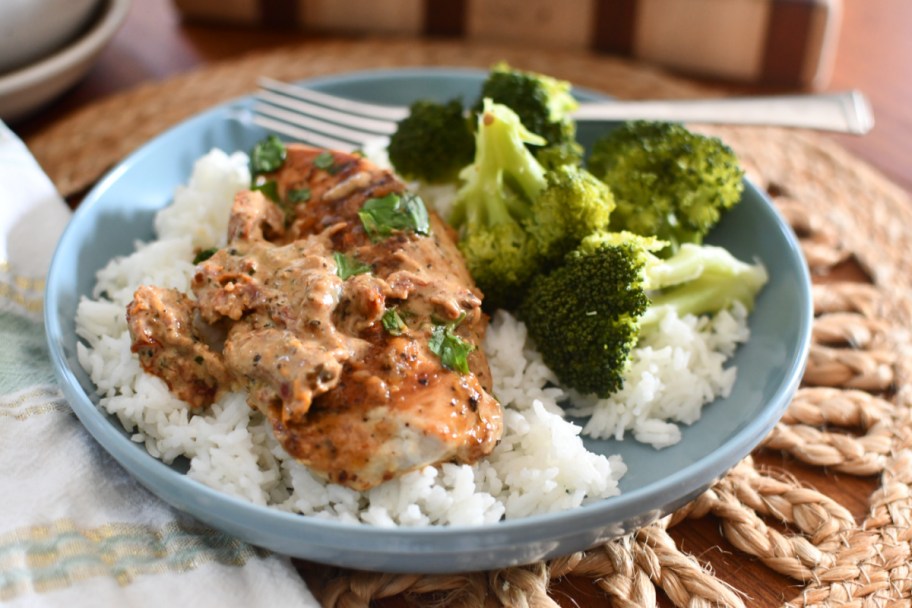 Our marry me chicken recipe on a plate with rice and broccoli 