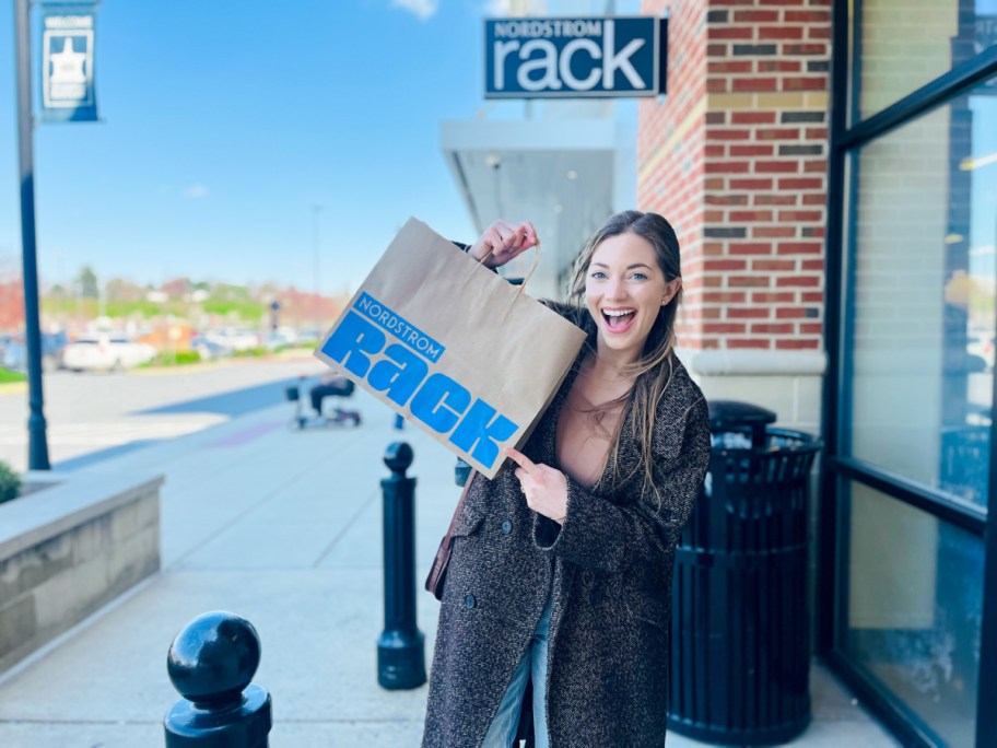 woman holding nordstrom rack bag outside