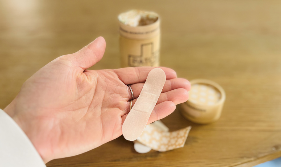 close up of hand holding a patch bandage