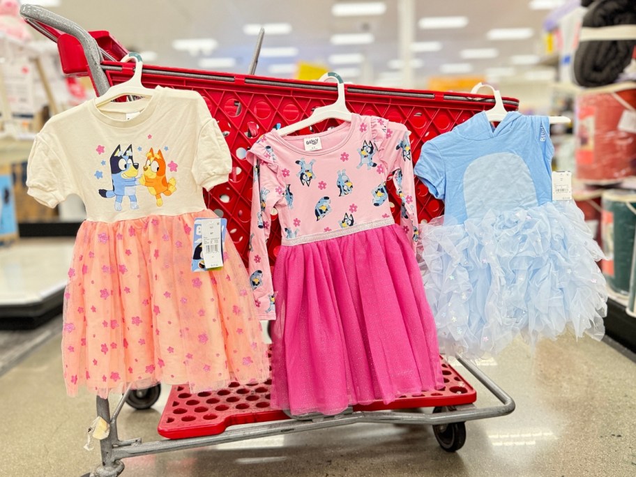 3 Bluey kid's dresses on a Target cart in different colors